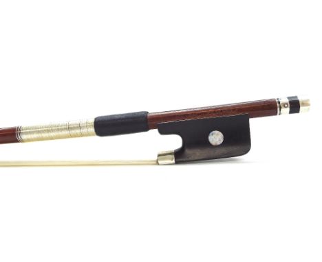 Silver mounted violin bow stamped ...a Paris, the stick round, the ebony frog inlaid with pearl eyes and the ebony adjuster w