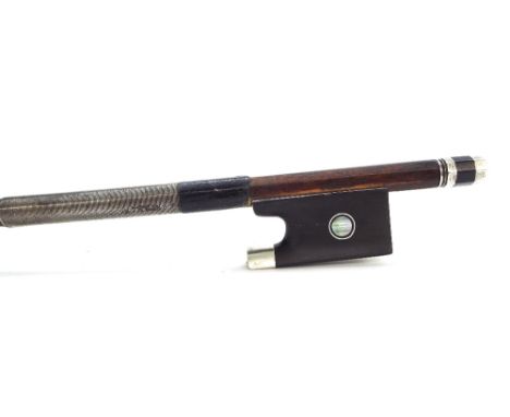 German silver mounted violin bow stamped Dodd, the stick round, the ebony frog inlaid with silver rings enclosing pearl eyes 