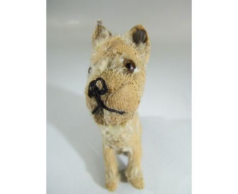 Steiff rotating head Rattler dog, 1930s, With beige mohair. Tag to ear and missing most of hair, but rotating mechanism still