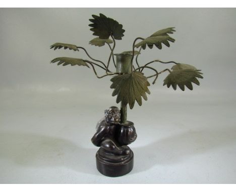 Mid Century 1970's bronze monkey holding a palm tree in the form of a candle holder