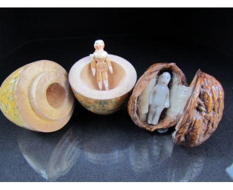 Behalf of the RNLI - Two trinket pieces - walnut case with miniature ceramic man and a carved wooden egg with miniature artic