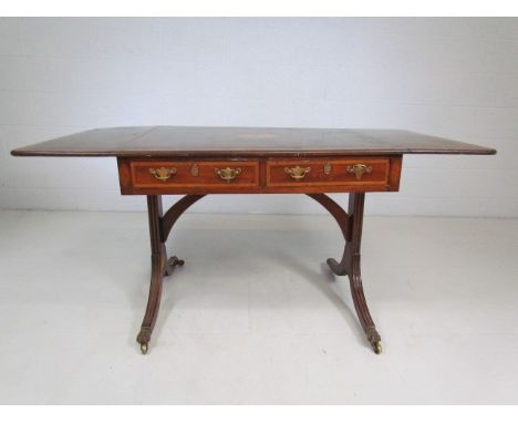 Edwardian sofa table inlaid with shell motifs and drawers. 