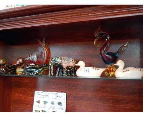 A shelf of birds, glass & china