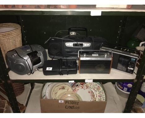 A shelf of assorted radios