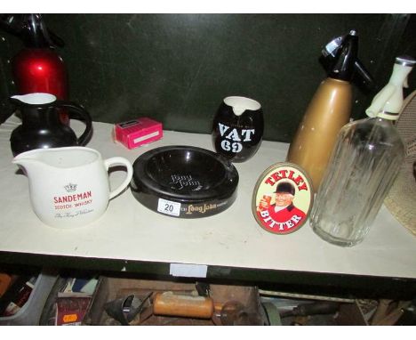 A shelf of breweriana including soda syphons, Wade jugs etc