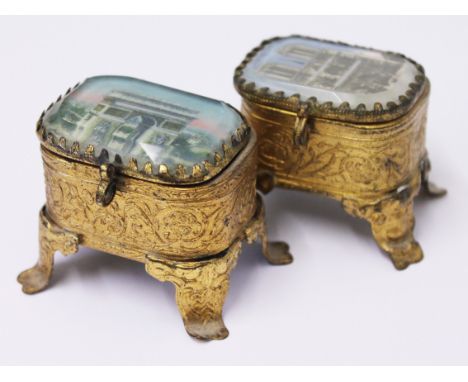 A pair of similar French gilt metal and glass souvenir trinket boxes, height 5cm each. Condition - good, no damage, general w