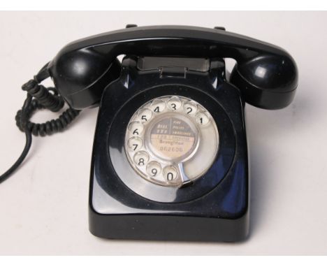 A black vintage telephone. Condition - good, no damage, general wear.