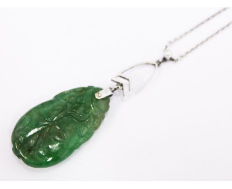 An Art Deco white metal and carved jade pendant set with a pearl on chain, pendant length 4.8cm, chain length 38cm
