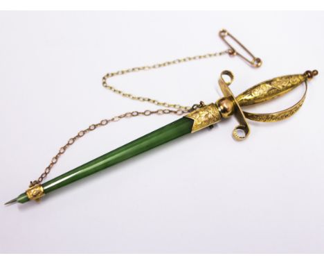 A 9ct gold mounted jade brooch in the form of a sword, length 9.5cm