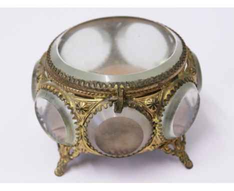 A gilt metal and glass panel trinket box with padded interior, diam. 9.5cm. Condition - no damage/repair, general wear.