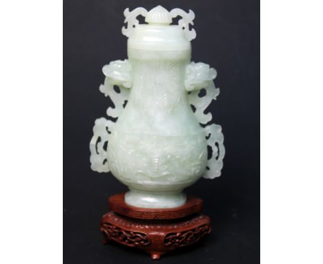 A Chinese archaic style carved jade vase on wooden stand, height 19cm. Condition - very good, no chips, cracks nor any repair