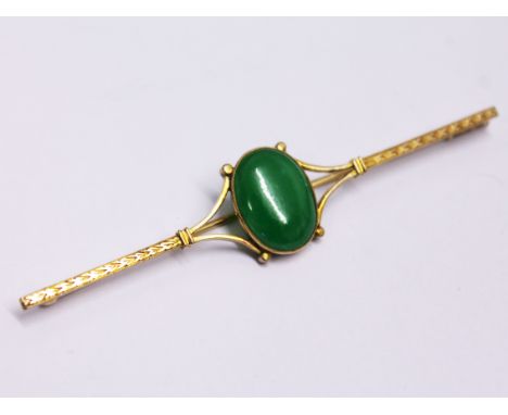 A yellow metal jade cabochon brooch, length 7.3cm, gross wt. 5.5g