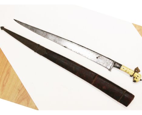 A North African Flyssa short sword with bone handle and leather scabbard, length 81.5cm. Condition - general wear to include 