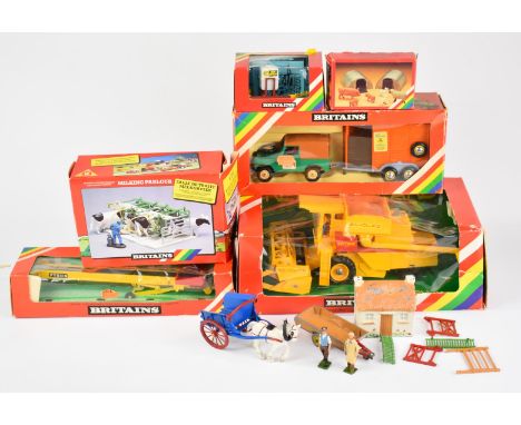 A collection of Britains diecast model farm vehicles and figures, most in original boxes.