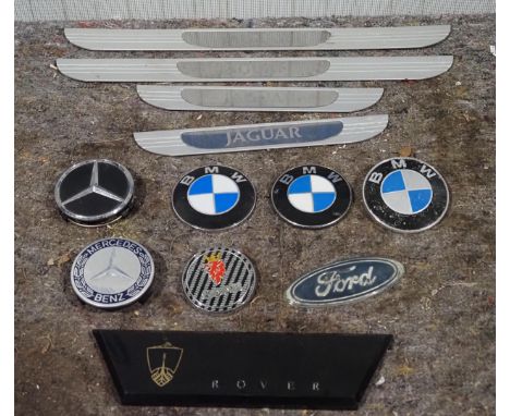 Assorted car badges to include BMW, Mercedes and Jaguar 