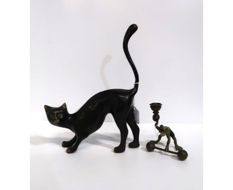 A bronzed metal cat and a cold painted candlestick of a frog lifting a dumbbell Condition Report:Available upon request