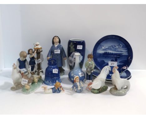 A collection of Royal Copenhagen figures of children, chickens and cockerels, two vases, bell, plates and a Nao hen group Con