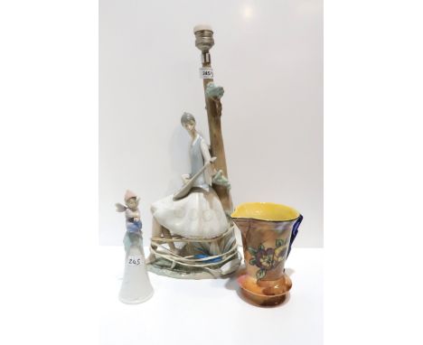A Lladro figural table lamp base of a girl playing a mandolin, a Lladro figural bell modelled as a fairy, an art deco H &amp;