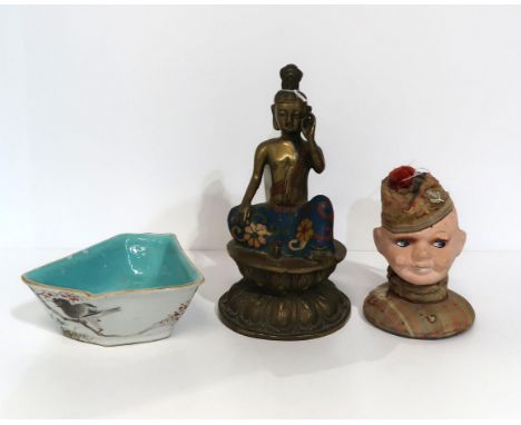 A brass buddha with enamel decoration, a Chinese sectional dish and a papier mache soldiers head pin cushion/needle holder Co