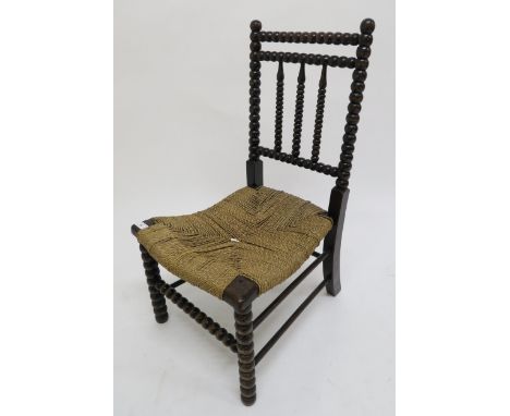 A 19th century stained Bobbin turned child's chair with strung seat Condition Report:Available upon request