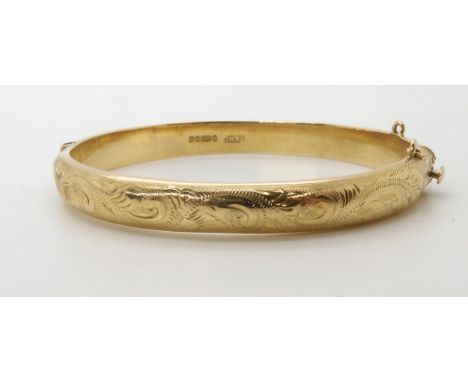 A 9ct gold engraved bangle, weight 12.5gms Condition Report:Available upon request