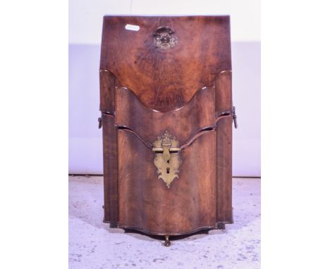 George III mahogany knife box, serpentine front, raised on three ball and claw feet, in the Chippendale style.