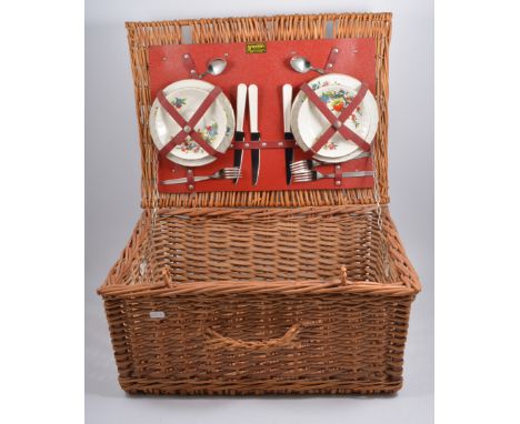A Brexton wicker picnic hamper, with fitted contents, four place settings and cutlery (lacking one fork, one knife, spoons)