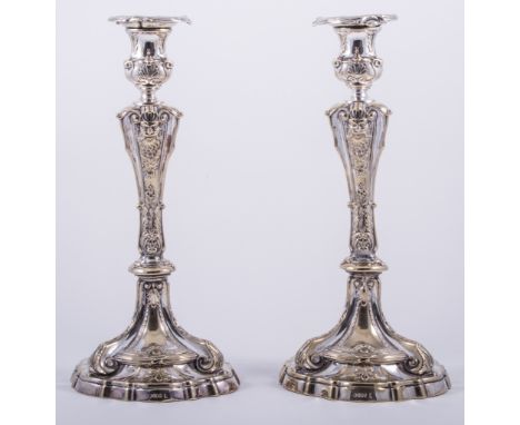 A pair of George II style electroplated table candlesticks, probably by Roberts & Slater, Sheffield, urn sconces, shouldered 