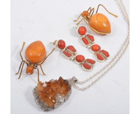 Two gilt metal bug brooches, amber coloured bodies, mounts stamped MET, a citrine rough crystal pendant in a silver coloured 