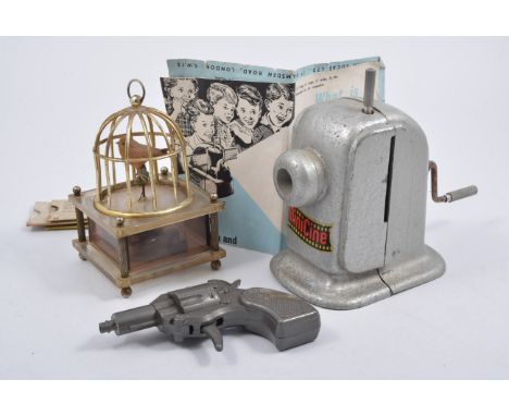 Vintage 1960s music box in the form of a mechanical automated bird in a cage, childs potato gun "Jetomatic" and a Minicine mo