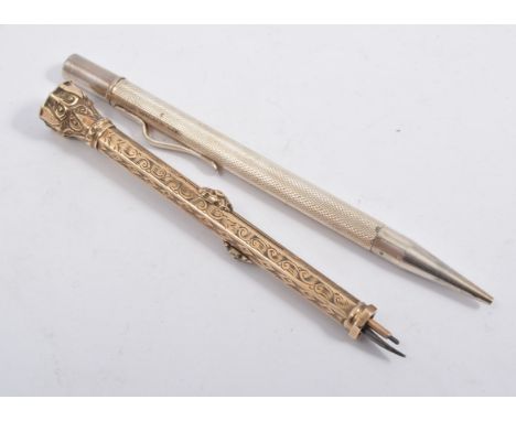 A silver engine turned propelling pencil in an Eversharp box and a dual pencil and pen nib in a gold coloured hexagonal barre