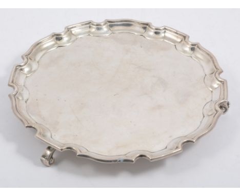 A silver Chippendale style salver, 20mm diameter supported on three scroll feet, hallmarked Birmingham 1932, approximate weig