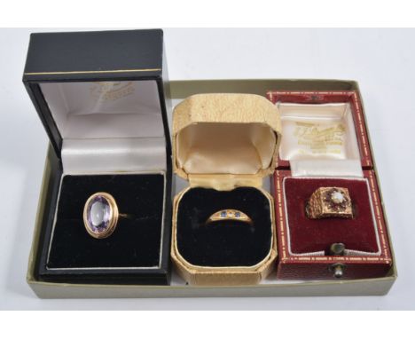 Three dress rings, a 9 carat yellow gold ring set with garnet and opal, size M, a 9 carat gold ring set with amethyst size l,