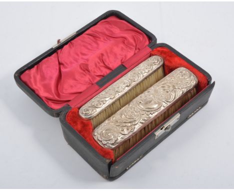 Three boxes containing a silver dressing table set, a hand mirror, two hair brushes and a comb, and two clothes brushes, hall