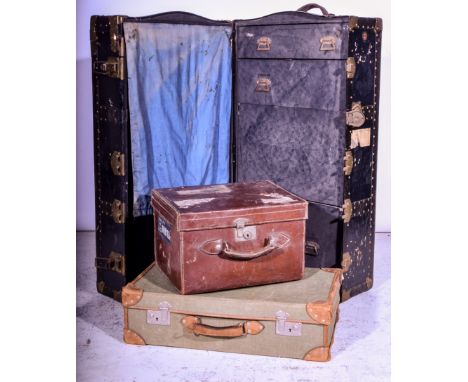 Canvas suitcase with leather mounts, a leather/fibre board case, together with a navy travelling wardrobe trunk, (3)
