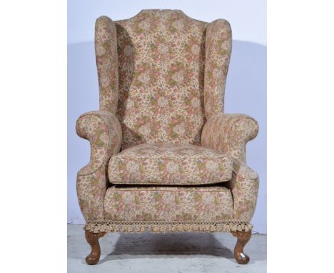 A 1930s wing-back armchair, floral tapestry upholstery, cabriole legs, width 82cm.