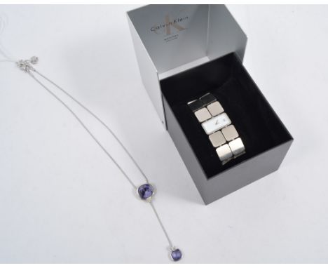 A Swarovski Crystal necklace, the snake link chain holding two purple stones, complete with Swarovski navy jewel pouch, a lad