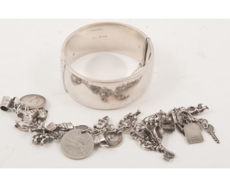 A hallmarked silver half-hinged bangle, scroll engraving to front, a "Peruvian Connection" white metal six strand bracelet, a