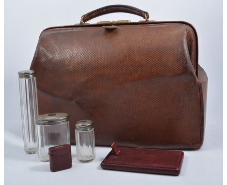 A Victorian leather Gladstone style travelling case, containing glove stretchers, page turner, mother-of-pearl handled manicu