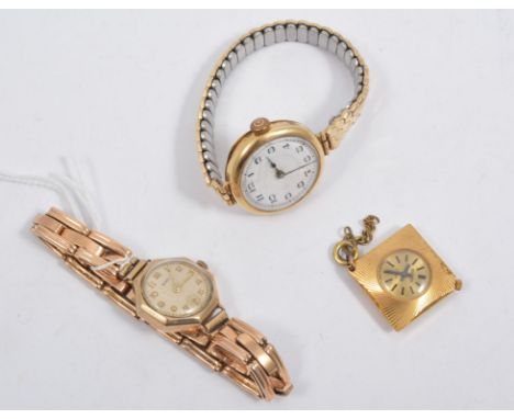 A ladies 18 carat yellow gold cased wrist watch with white enamel arabic dial on a metal expanding bracelet, a ladies 9 carat