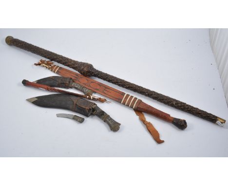 Matching African tribal sword and knife in scabbards, two Gurkha kukris in scabbards, one sword stick. (5)