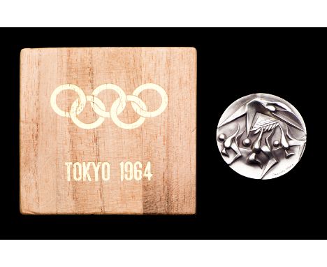 Tokyo 1964 Olympic Games participant's medal,
designed by T. Okamoto and K. Tanaka, stylised three runners and a swimmer, rev