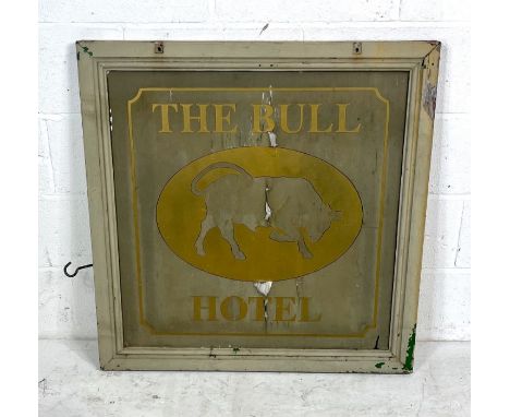 A vintage double sided wooden advertising sign for "The Bull Hotel".  Shows signs of wear consistent with age.