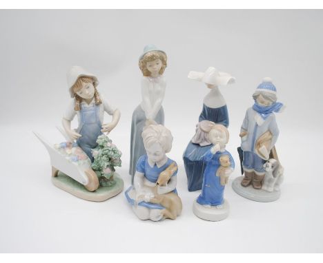 A collection of Lladro and Nao figurines. 