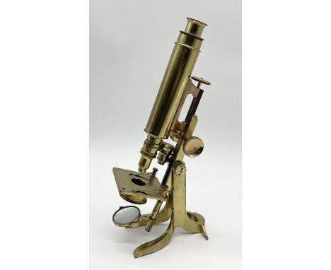 A brass microscope by Collins of London on Y shaped tripod base 