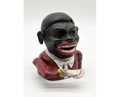 A vintage cast iron novelty money bank