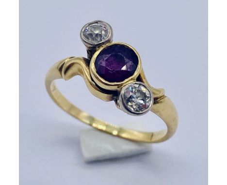 An 18ct gold ruby and diamond three stone ring