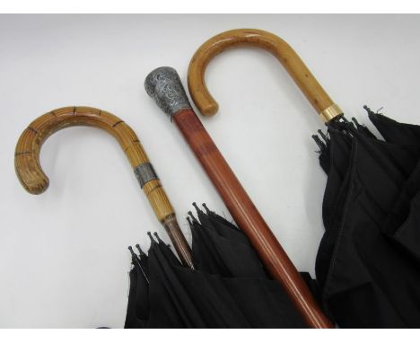 Two vintage umbrellas one with a silver collar and the other marked "Paragon, S Fox & Co" with yellow metal collar along with