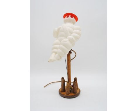 A vintage Michelin man lamp with table skittle base - height 46cm