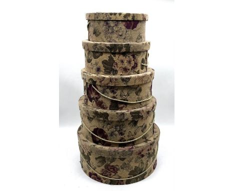 A vintage set of five nesting hat boxes with lids.